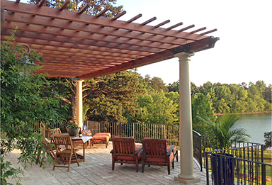 Construction Heart redwood beams create an outdoor room with a beautiful view of the lake.